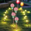 Solar candy cane garden lights glowing at night.