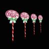Four spiral lollipops with green bows on sticks.