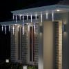 House with icicle Christmas lights at night.