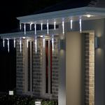 House with icicle Christmas lights at night.