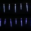 LED icicle lights hanging in dark backdrop.