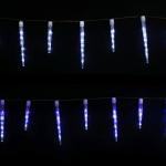 LED icicle lights hanging in dark backdrop.