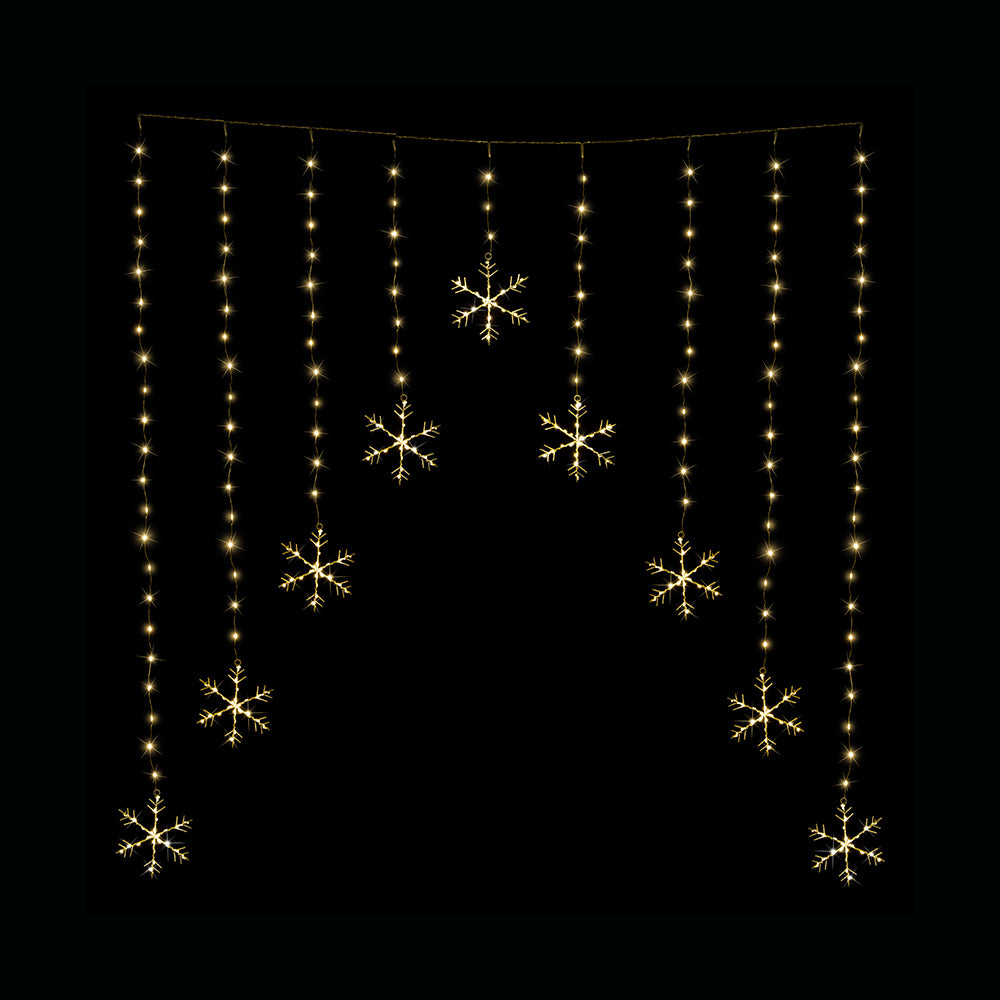 Golden snowflake LED curtain lights on black background.