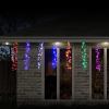 led rainbow cluster strand lights digital Colourful Christmas icicle lights on a house at night.