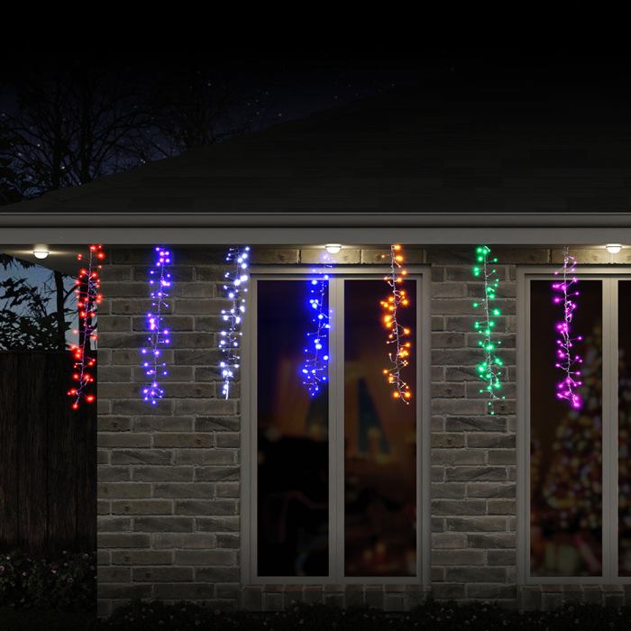 led rainbow cluster strand lights digital Colourful Christmas icicle lights on a house at night.