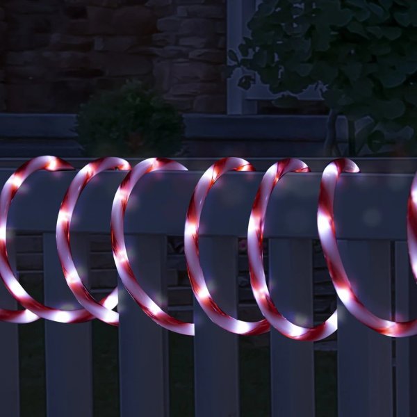 led candy tubelight 8m flashing Festive candy cane lights on garden railing at night.