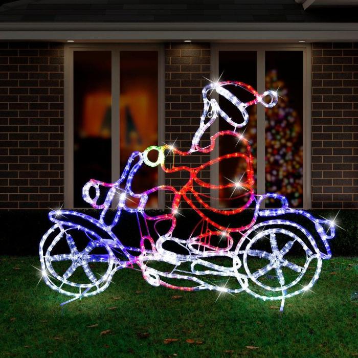 Santa LED lights on motorbike decoration at night.