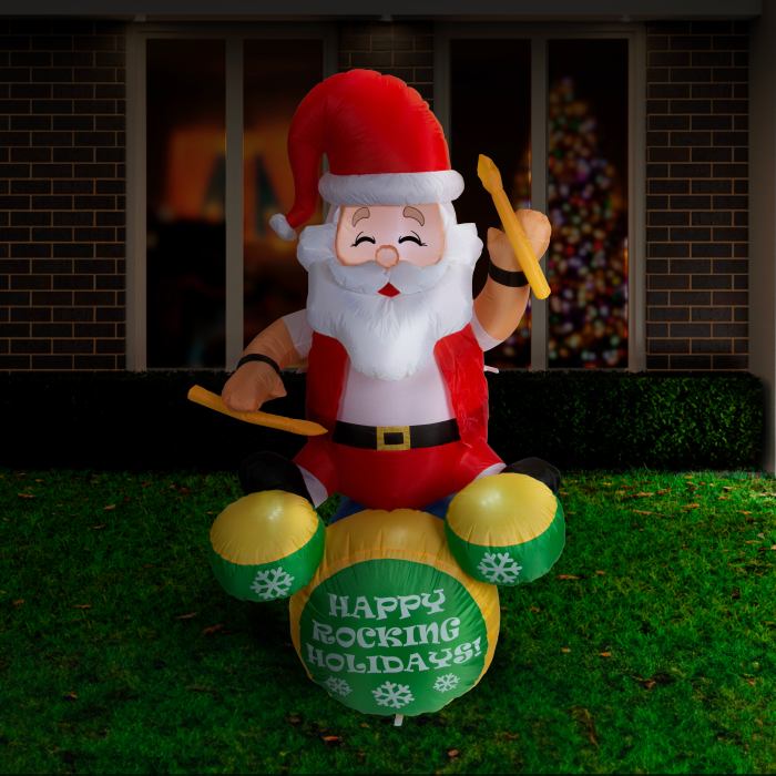 Inflatable Santa playing drums, 'Happy Rocking Holidays'.