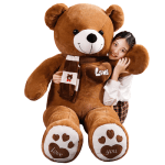 Woman hugging large plush teddy bear with scarf.