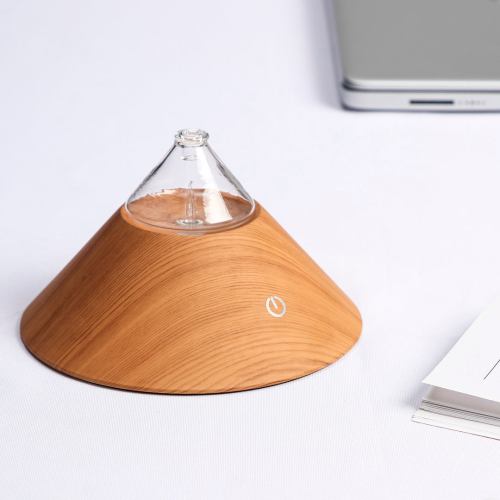 Wooden essential oil diffuser on table