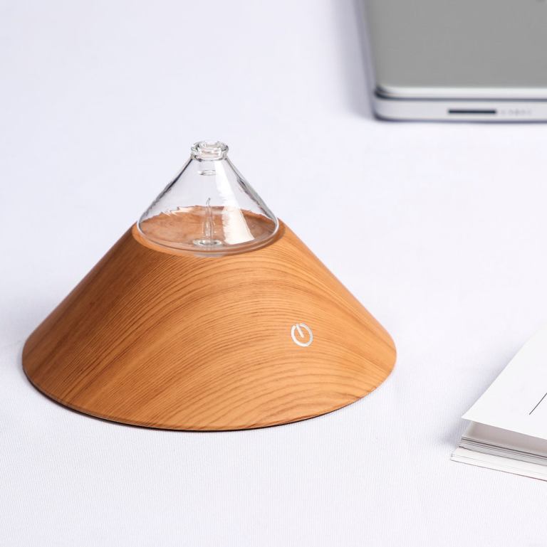 Wooden essential oil diffuser on table