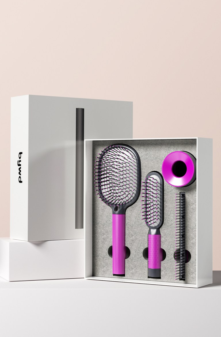 Pink hairbrush and comb set in packaging.