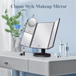 Tri-fold makeup mirror with LED lights on table.