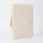 Beige quilted fabric folder with geometric patterns.
