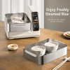 Rice steamer with bowls of steamed rice