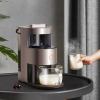 Person serving hot milk with milk frother.