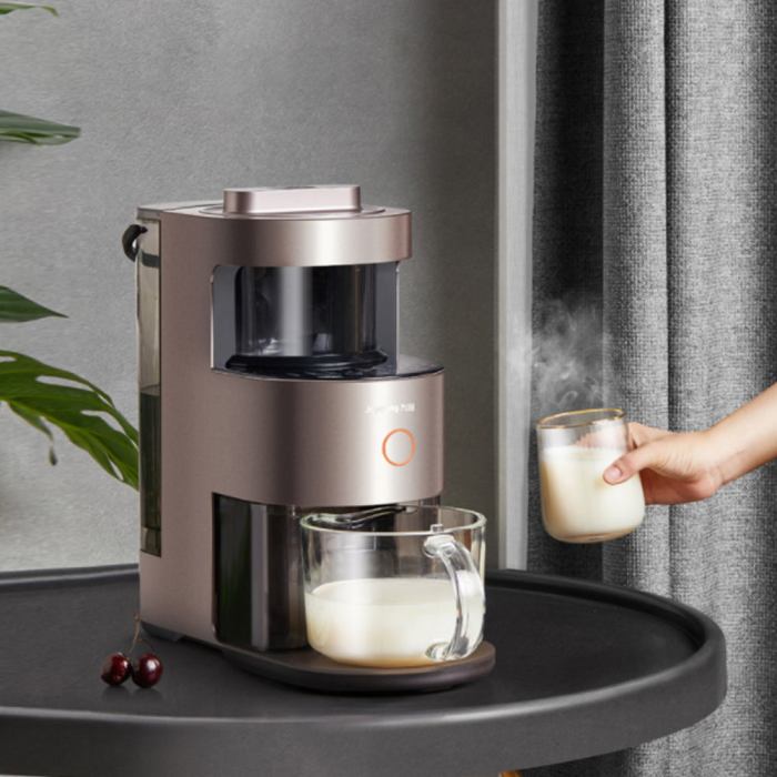 Person serving hot milk with milk frother.