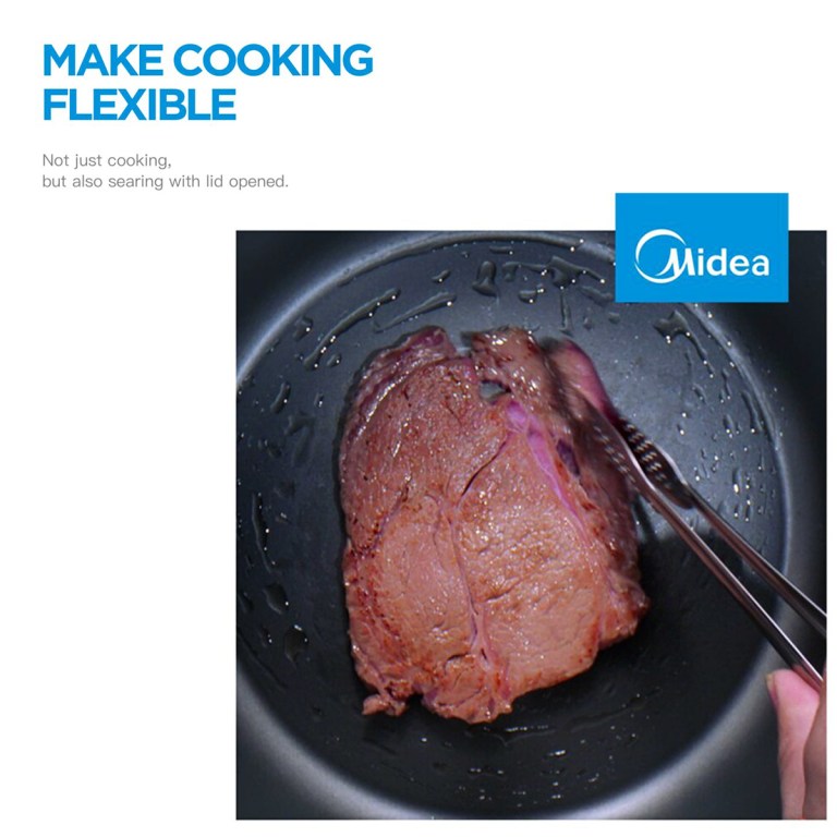 Steak cooking in Midea pan with tongs.