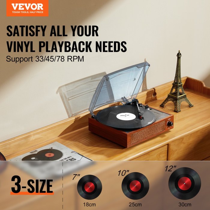 Turntable with vinyl records and Eiffel Tower model.