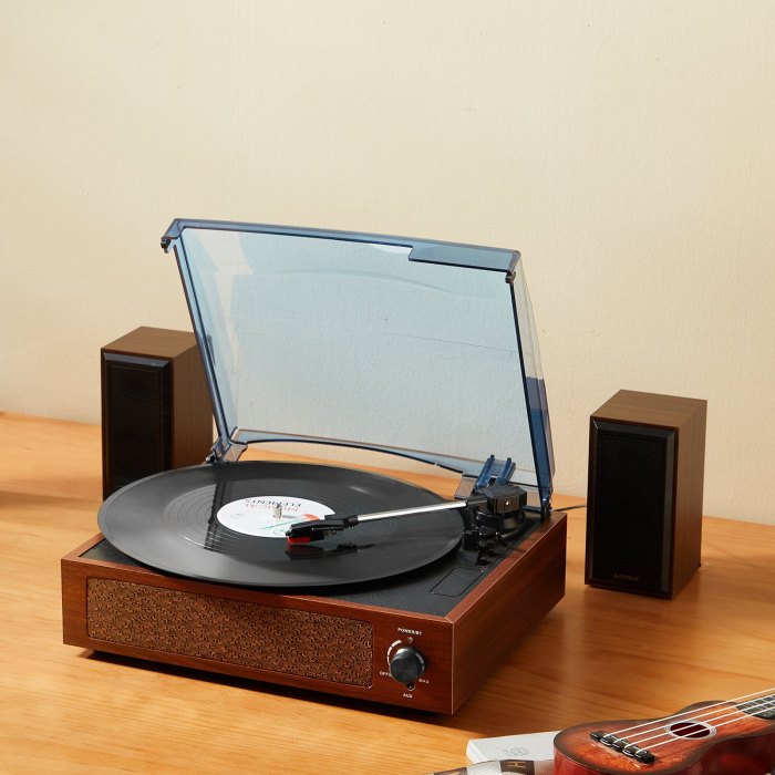 Vintage record player with vinyl and speakers.