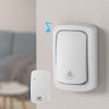 Wireless doorbell button and chime set on wall.