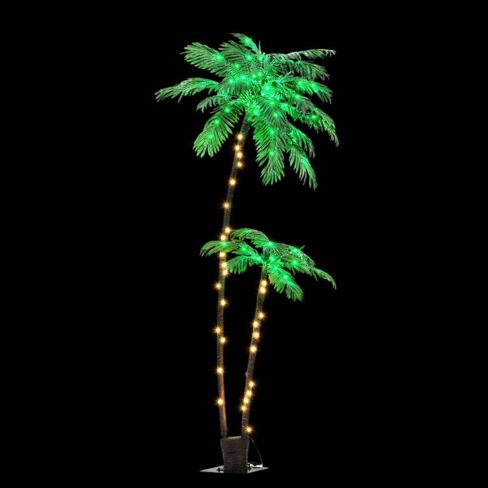 Artificial palm tree with LED lights on dark background.