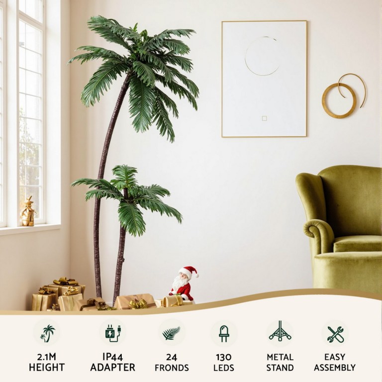 Decorative palm tree with Christmas presents and Santa figurine.