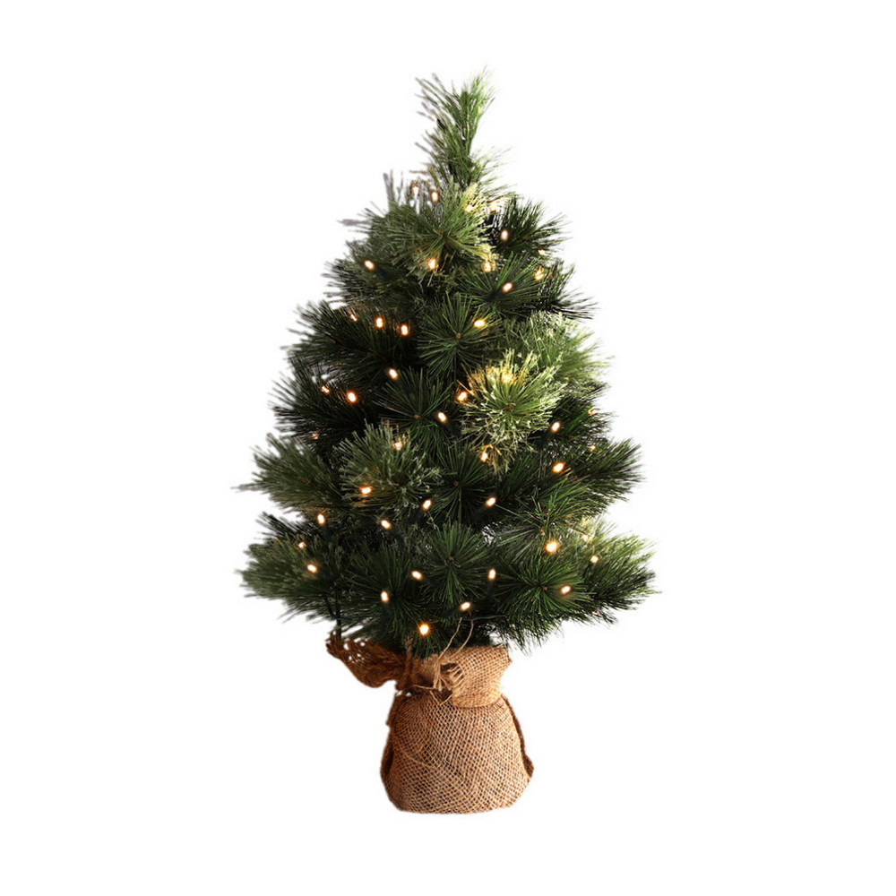 xm tr mini 2ft gr led 202508061628 00.jpg Small Christmas tree with lights and burlap base.
