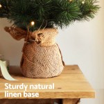 jingle jollys christmas tree 60cm mini tabletop 8 light modes timer xmas tree Christmas tree with linen wrapped base on table.