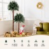 Christmas decorations with small Santa, gifts, and trees in room.