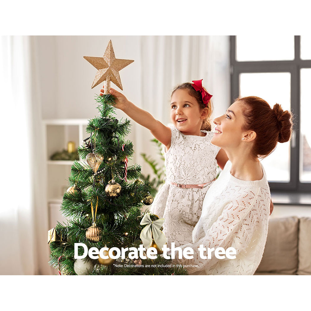 Mother and daughter decorating Christmas tree together.
