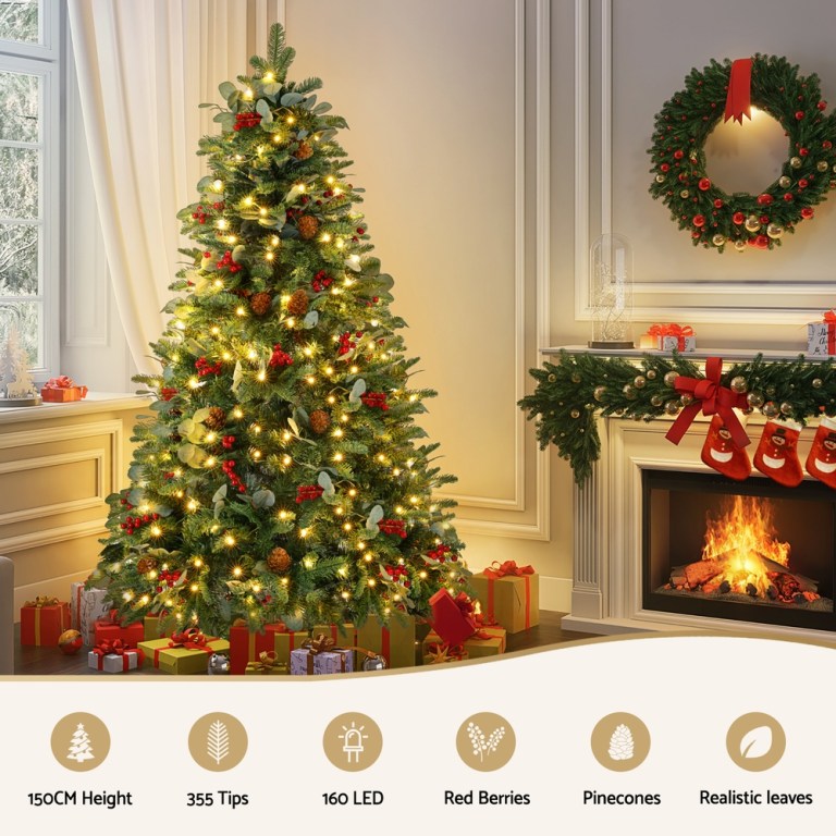 jingle jollys christmas tree 1.5m 160 led xmas tree party decorations 355 tips Decorated Christmas tree beside a lit fireplace.