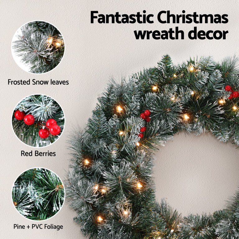 Christmas wreath with frosted leaves and red berries.