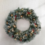 Festive Christmas wreath with lights and berries.