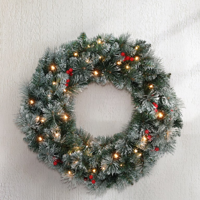 Festive Christmas wreath with lights and berries.