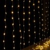 Warm white string lights in darkness.