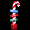 Candy cane pole with North Pole signs.