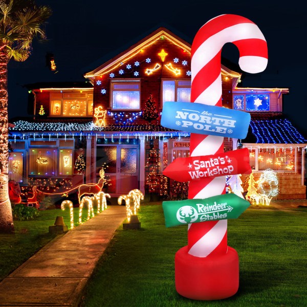 Festive house with North Pole candy cane sign.