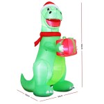 Inflatable Christmas dinosaur holding gift, wearing Santa hat.