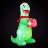 Inflatable Christmas dinosaur holding a wrapped present.