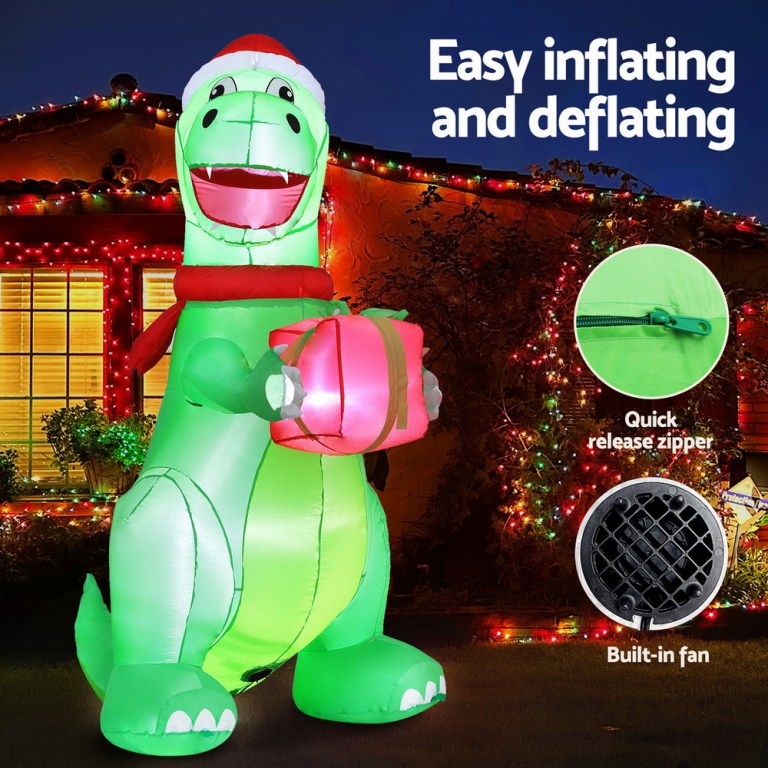 Inflatable dinosaur with gift, Christmas lights background.