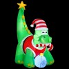 xmas inf dino gr 6ft 202508061852 00.jpg Inflatable dinosaur with Santa hat and candy cane.