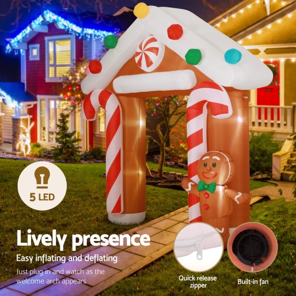 jingle jollys christmas inflatable archwary ginger 2.8m illuminated decorations Inflatable gingerbread arch with Christmas lights at night.