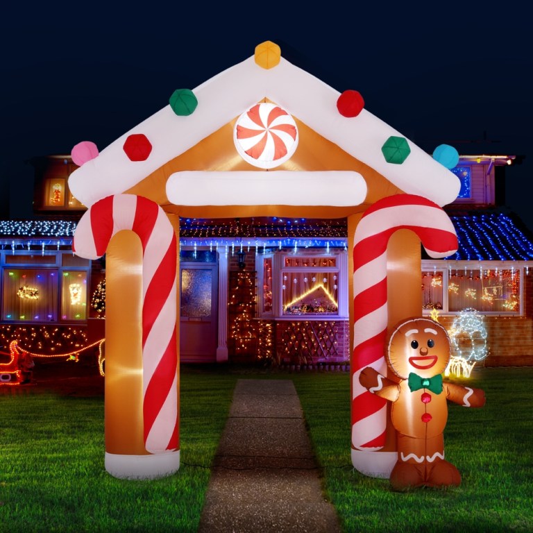 Inflatable candy cane arch with Christmas lights display.