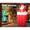 Inflatable Santa climbing chimney decoration with LED lights.