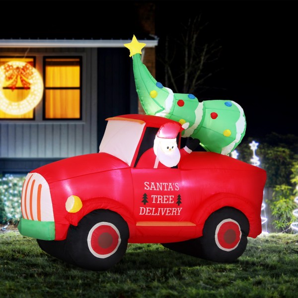 Inflatable Santa in red truck with Christmas tree