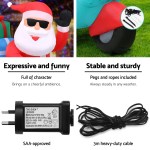 Inflatable Santa decoration with power adapter, stable setup.