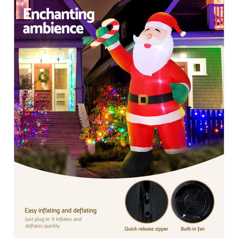 Inflatable Santa with candy cane, outdoor Christmas lights.
