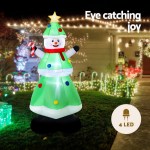 Inflatable snowman with LED lights in yard
