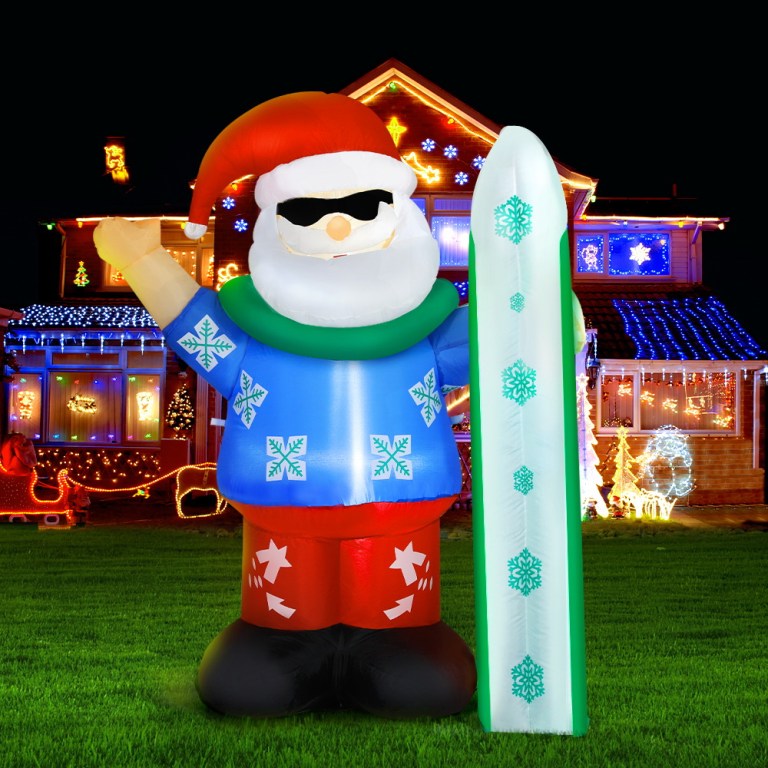 Inflatable Santa with surfboard, Christmas lights display.